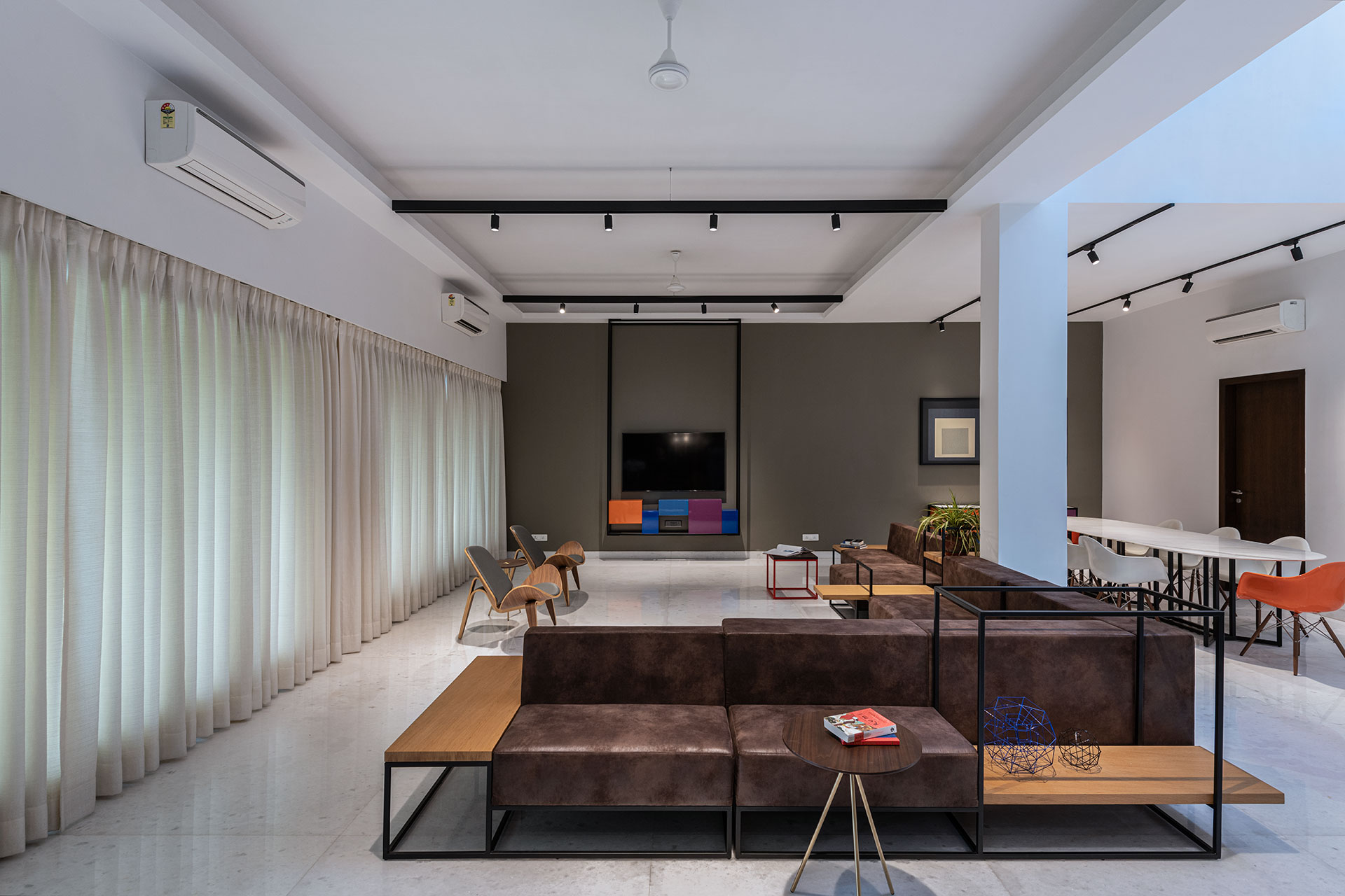 This spacious large house is used for hosting weekend parties and getaways.  In the open style living room space, the custom designed Synecdoche Sofa opens onto three directions , with each extending arm opening towards dining, bar lounge space and central seating.