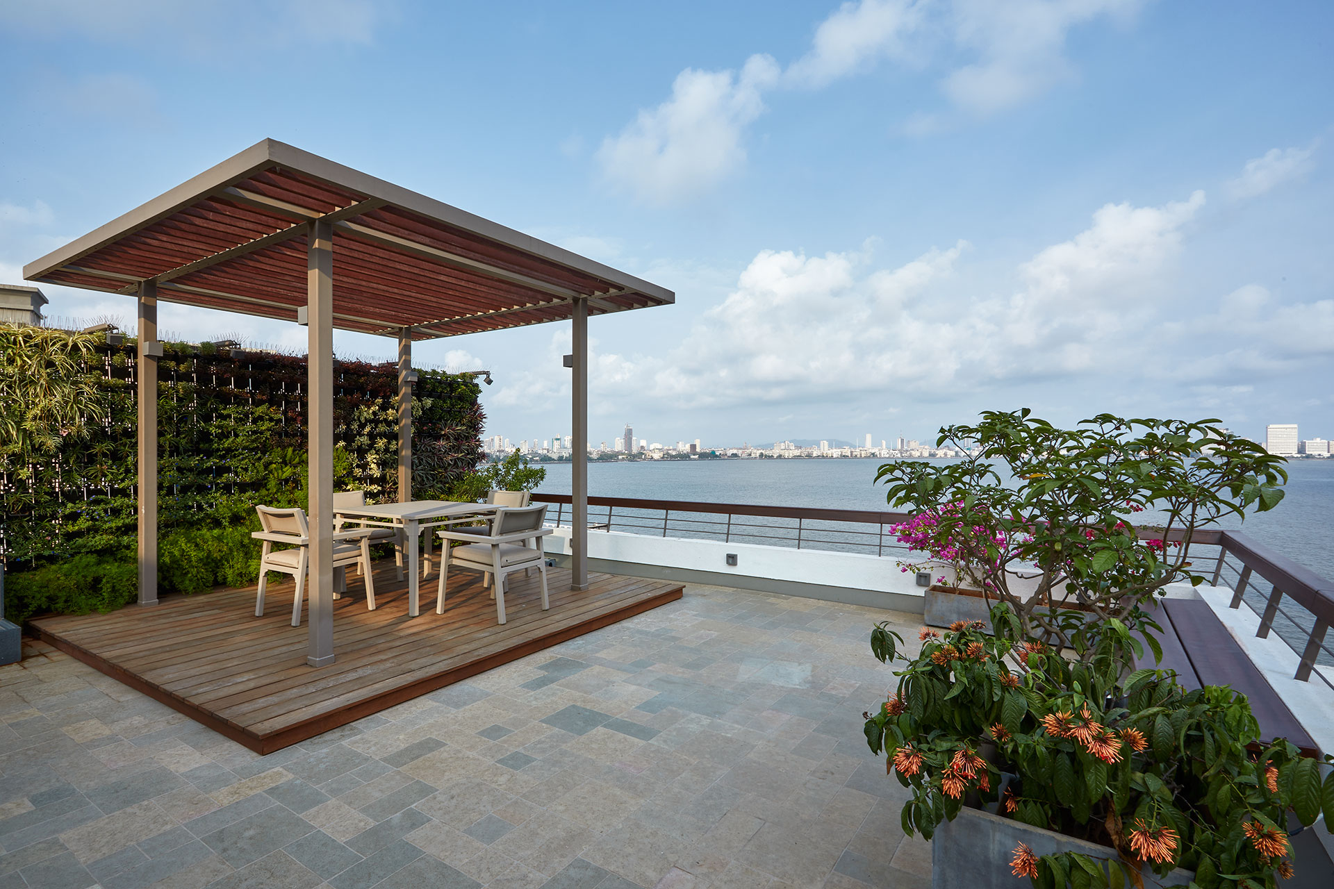 Most of the family’s entertaining takes place outdoors, on the terrace. A pergola seating, a dining area, a bar counter, a green wall that ended in a stepwell water feature were all added to the terrace, while keeping the views clear from the living and dining area.